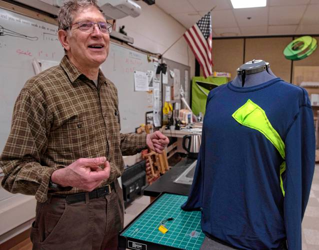 John Fabel, the adviser for the InvenTeam at Amherst Regional High School, with a prototype of a garment called SARAH, Search And Rescue Assistant Hardware.