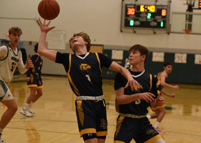 Hopkins Academy’s Owen Earle, left, pulls down a rebound against Greenfield earlier this season.