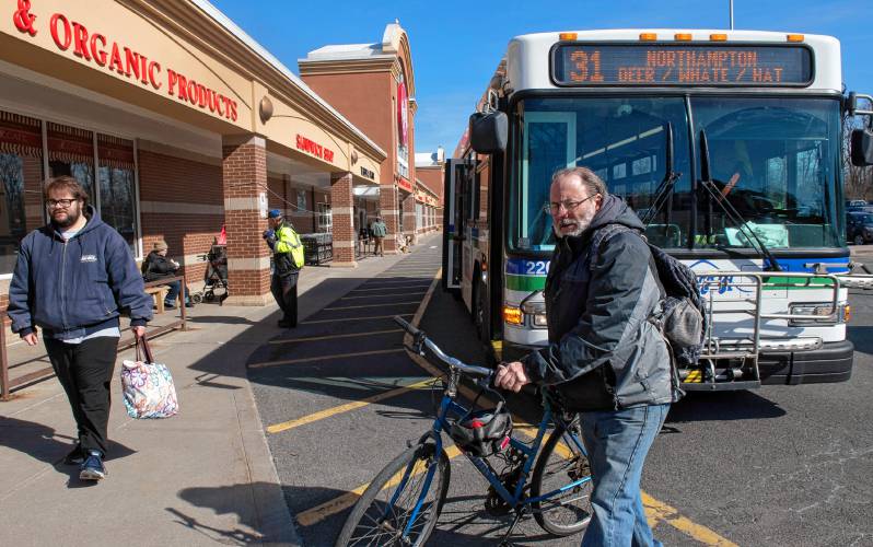 David Grace of Greenfield gets his bike off the bus at the Big Y stop in Northampton. “These buses are very important for grocery shopping; it’s  crucial,” he said.