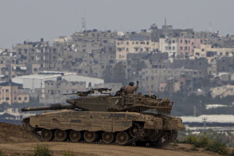 An Israeli soldier on top a tank on the border with the Gaza Strip, in southern Israel, Sunday, Sunday, March 17, 2024.