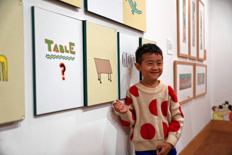 Siun Kim, 6, interacts with artwork by Seymour Chwast at the “Kid in a Candy Store” exhibit.