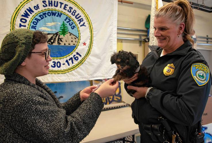 Shutesbury Town Clerk Grace Bannasch, left, and Police Chief Kristin Burgess swear in Charlie, the newly added 9-week-old comfort dog, to the  town’s Police Department. “People see him and immediately melt,” said Bannasch. 