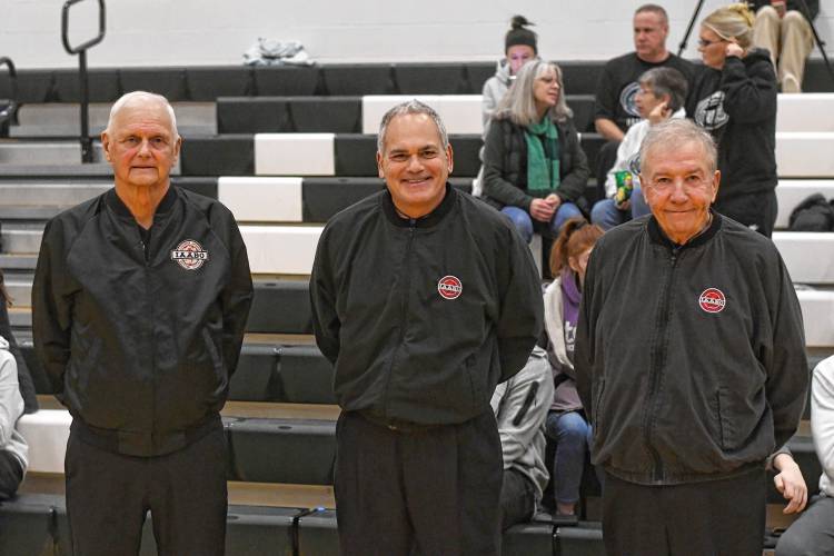 Referees Mike Korpita, Mark Grumoli and Bob McGee get ready to officiate the boys basketball game between Greenfield and Frontier in Greenfield on Jan. 26.  